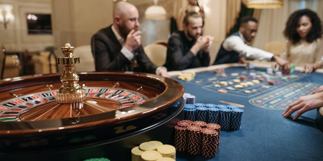 Men and women placing their bets when playing roulette in a casino