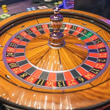 A Roulette wheel with game chips in the background