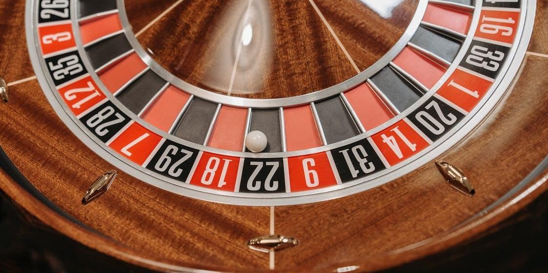 A close-up of a roulette wheel in a casino