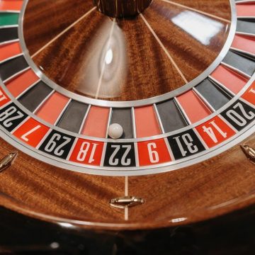 A close-up of a roulette wheel in a casino