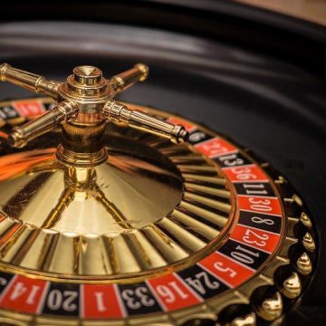 Close-up of a roulette wheel in a casino against a dark background