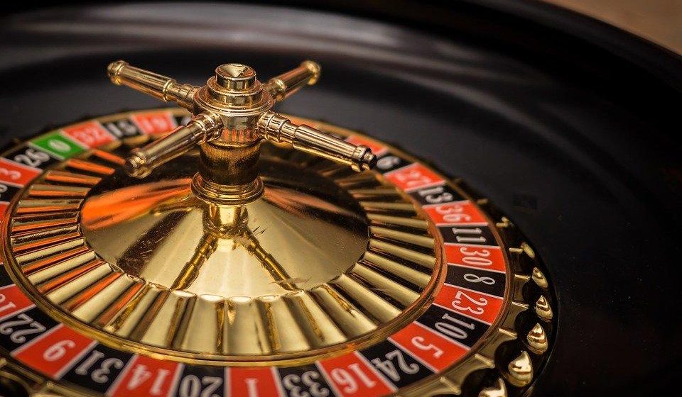 Close-up of a roulette wheel in a casino against a dark background