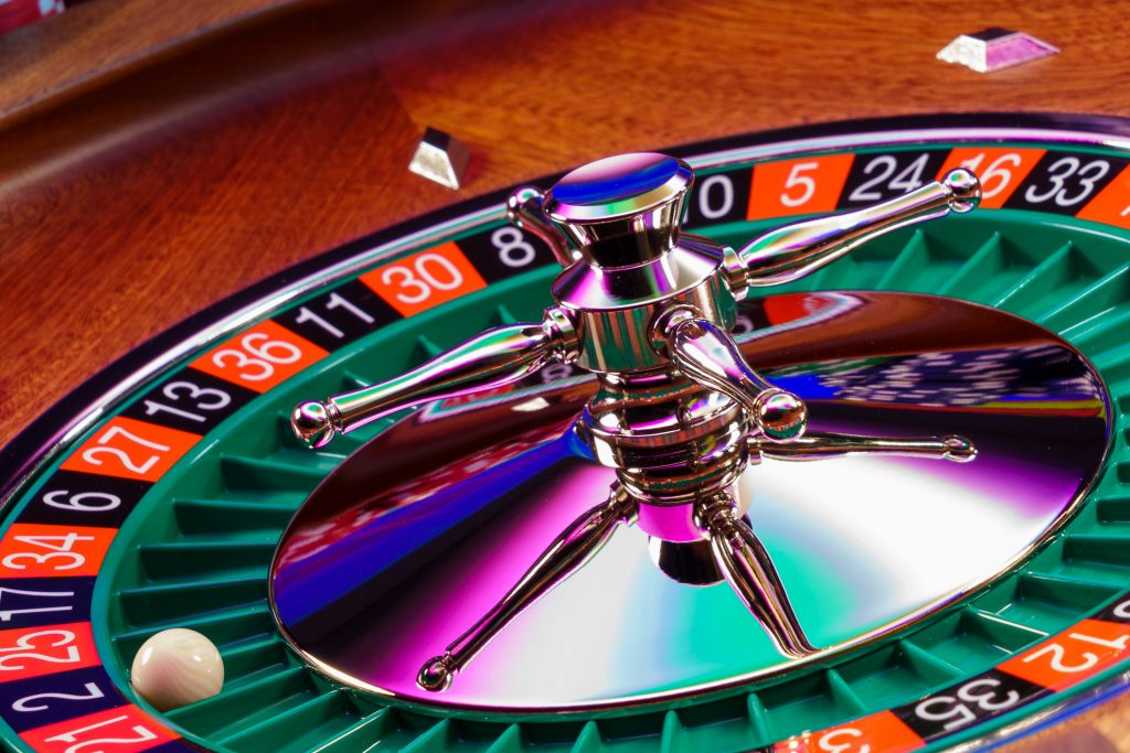 A roulette wheel against a dark background
