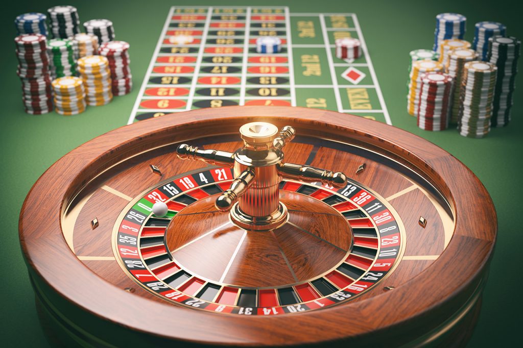 Roulette Wheel & Casino Chips on a Green Table