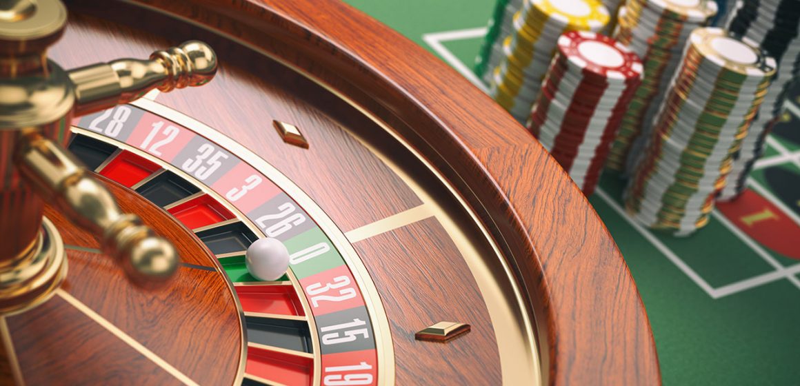 Betting Chips Neatly Stacked Next to the Roulette Wheel