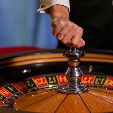 Roulette players around a roulette wheel