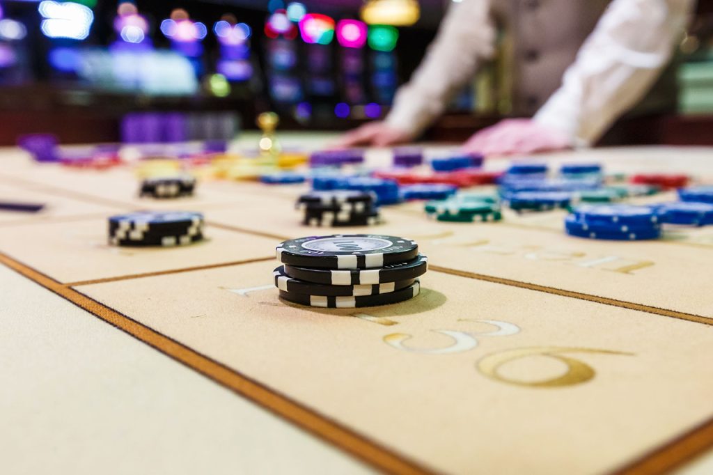 Gambling chips on a roulette game table
